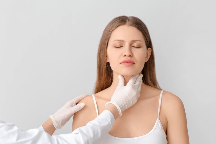 Clinician assessing jaw and neck during a neck lift consultation